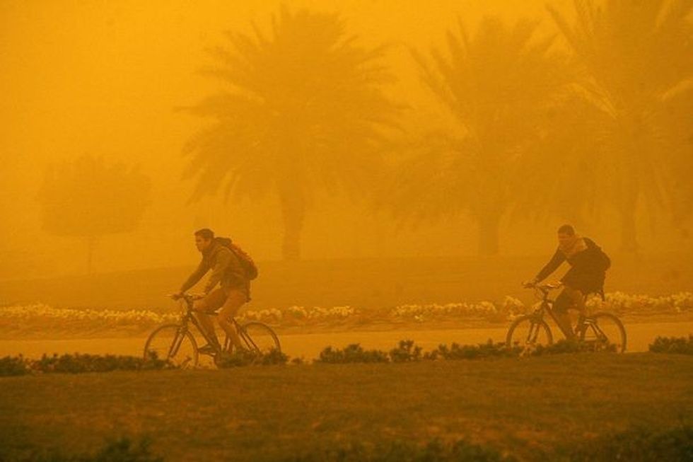 0 Foreigners ride their bicycles during a
