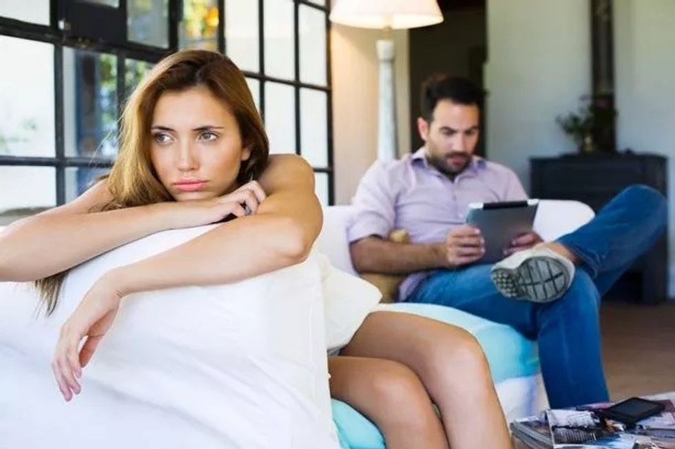 0 Woman displeased by boyfriend on digital tablet
