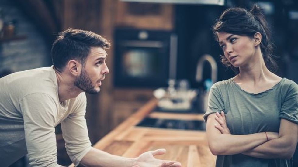 0 Young couple arguing while havi