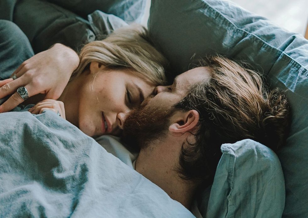 01 things better sleep woman stretching bed