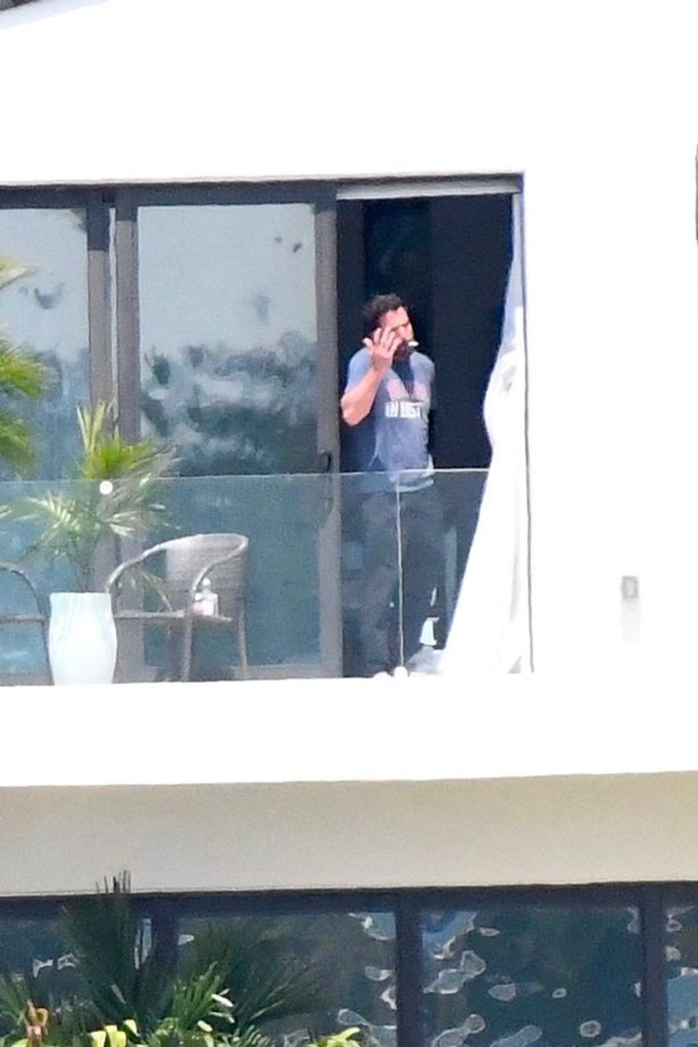 1 EXCLUSIVE JLo is ethereal in white while Ben Affleck puffs on a cigarette as couple relax at lavish