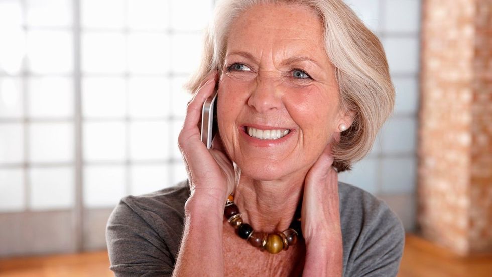 1 Mature woman talking on mobile phone
