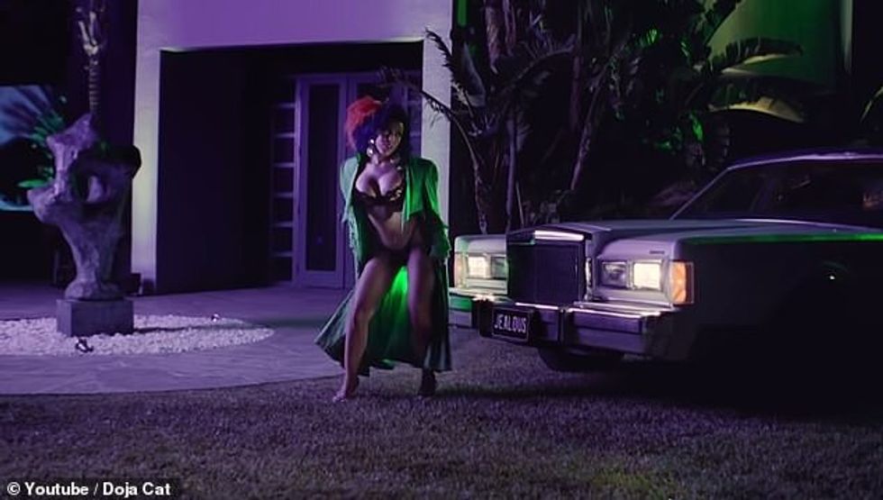 101454325 15023821 One wore a long green coat and revealing black lingerie undernea a 9 1755874677318