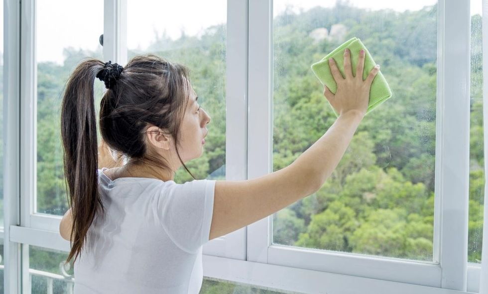1200 53196354 woman cleaning window