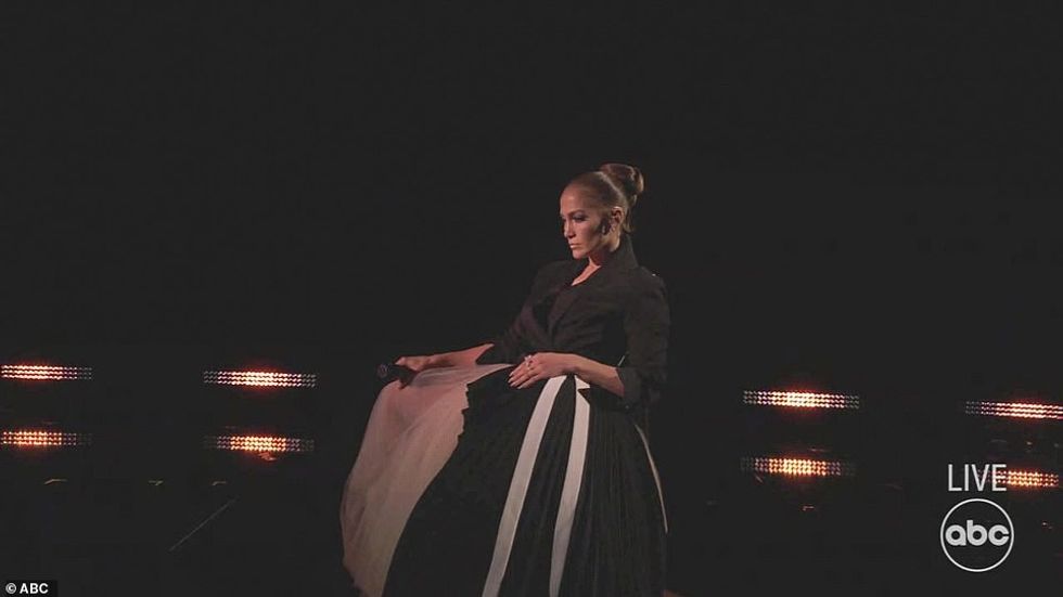 1637559382 569 Jennifer Lopez performs in a WEDDING dress but no sign