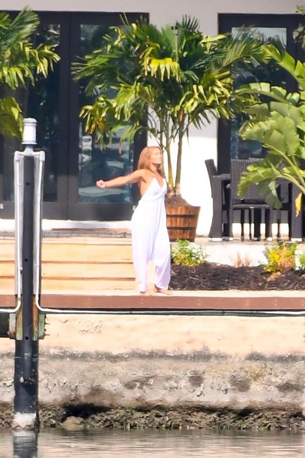 2 EXCLUSIVE JLo is ethereal in white while Ben Affleck puffs on a cigarette as couple relax at lavish