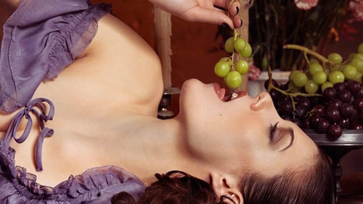 2014/11/beautiful-woman-eating-grapes-on-a-festive-table-oleksiy-maksymenko.jpg