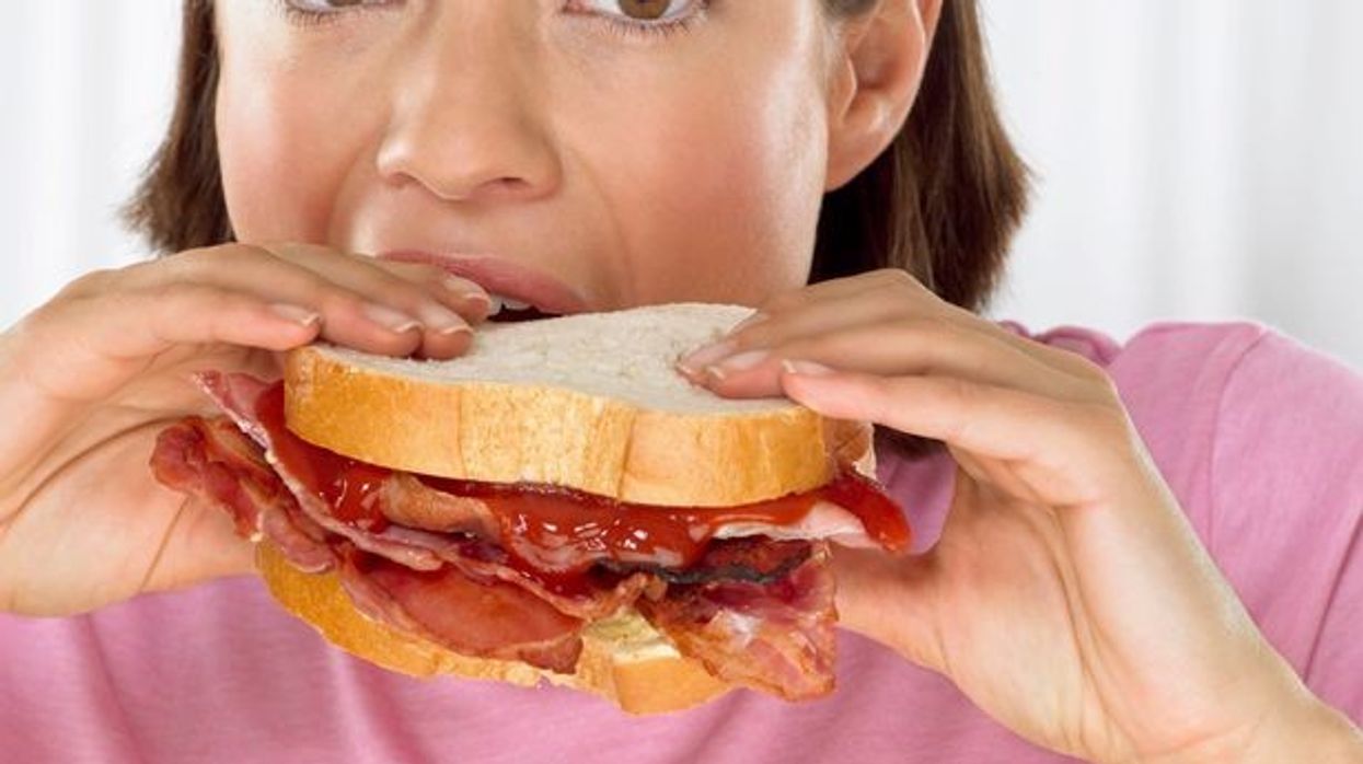 2016/04/Young-woman-biting-into-a-bacon-sandwich.jpg