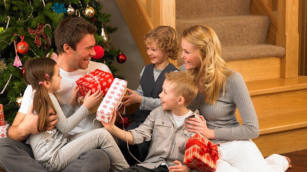 2017/12/family-exchanging-presents-at-christmas.jpg
