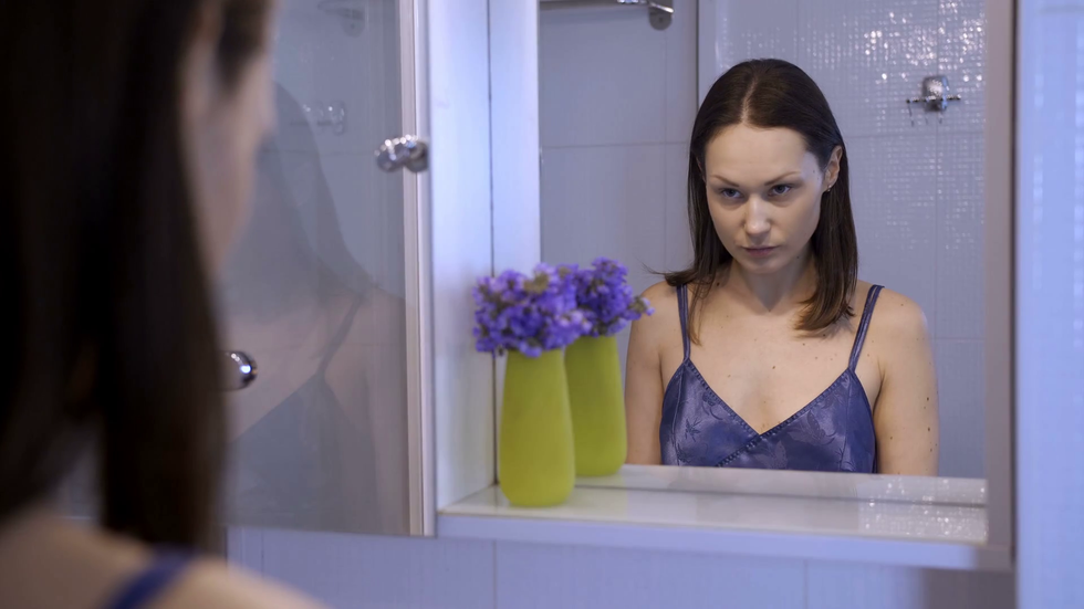 2019/02/videoblocks-reflection-of-unhappy-young-woman-looking-at-her-f.png