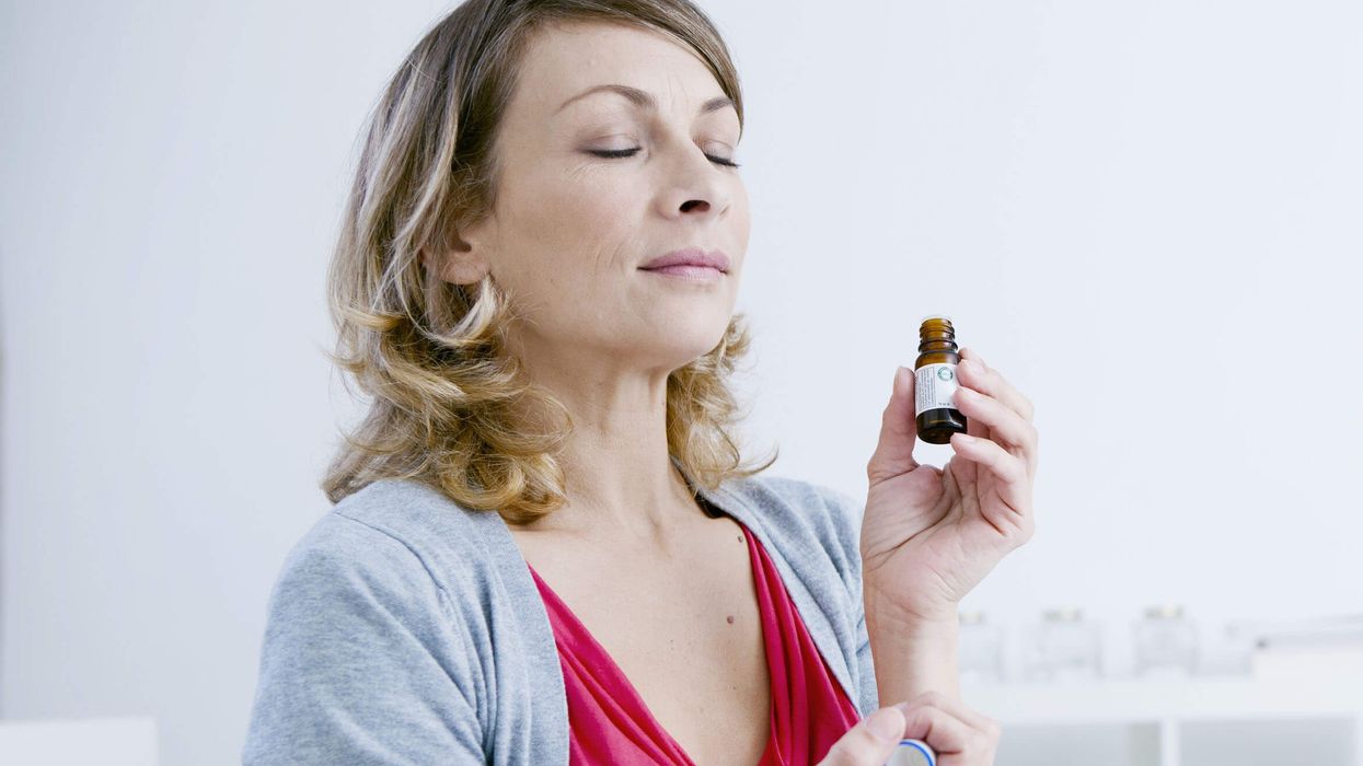 2022/07/Woman-smelling-essential-oil-extract.jpg