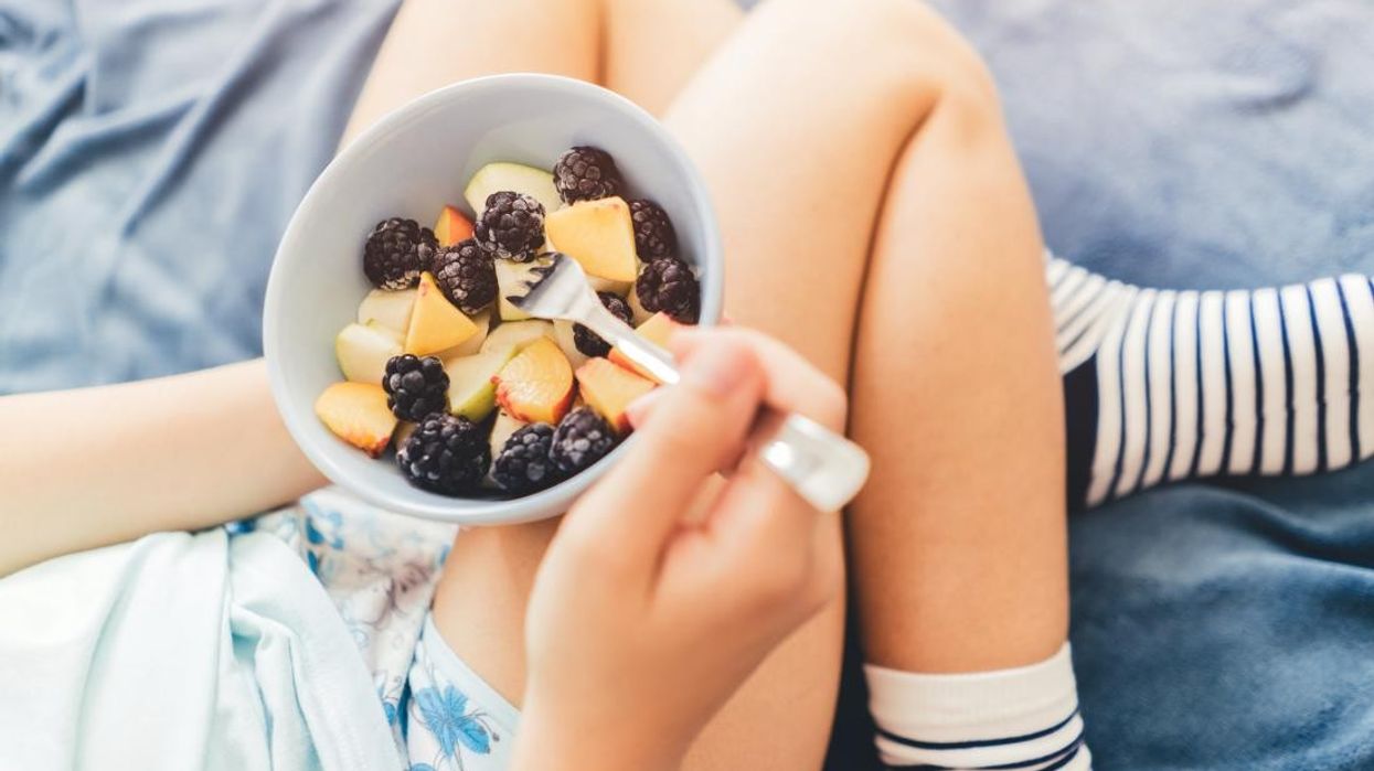 2022/08/woman-eats-fruit-salad.jpg