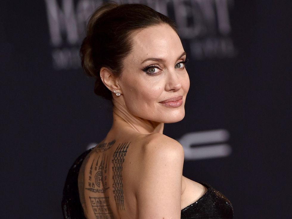 2023/03/angelina-jolie-tattoos-1-e27145be1d874bba8218bdeba249efed-e1680125982114.jpg