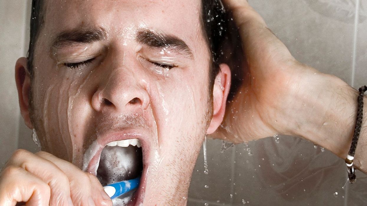 2023/05/0_Man-brushing-his-teeth-in-the-shower.jpg