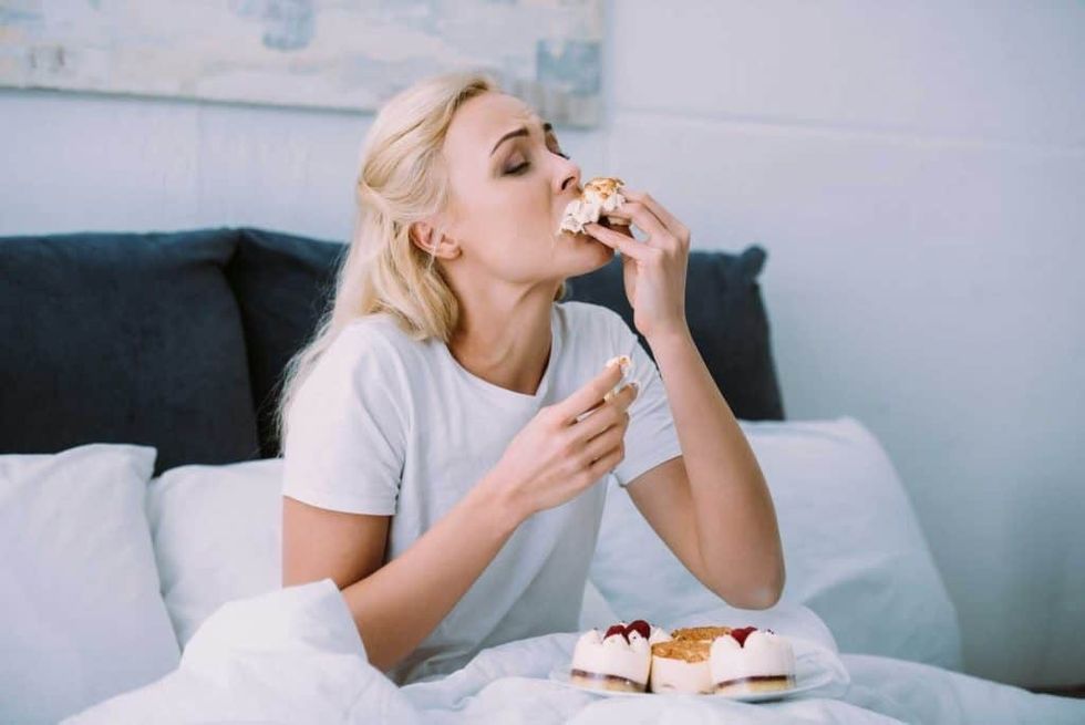 2023/06/woman-eating-cake-in-bed-1024x684-1.jpg