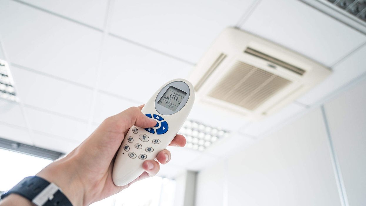 2023/07/controlling-office-room-temperature-with-air-conditioning-remote-control-2210x1473-1.jpg