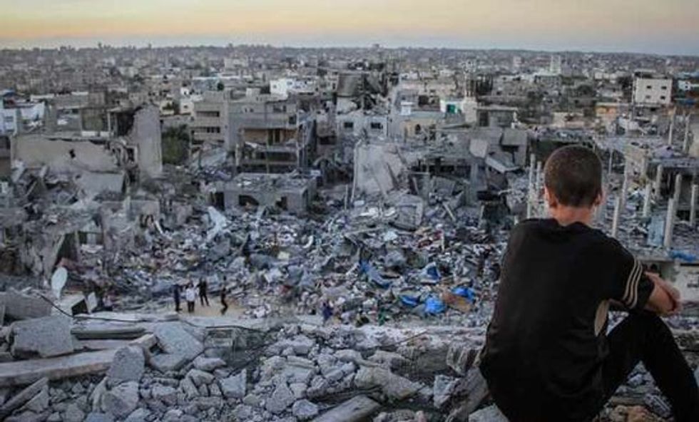 2023/11/202472_a_palestinian_child_sits_above_the_ruins_of_his_ruined_home_0.jpg
