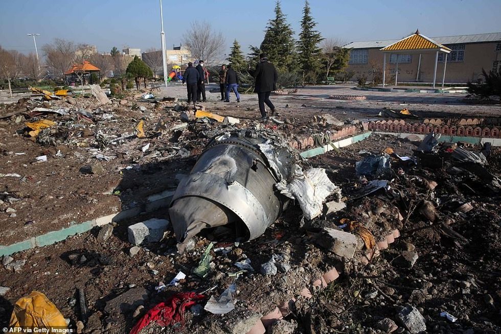 23183444 7868035 Wreckage of the plane which investigators in Iran say was trying a 26 1578592148183
