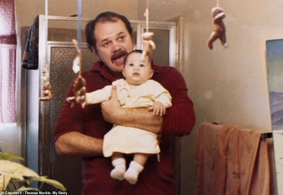 23764050 7919863 Thomas holds his daughter who he described as his pride and joy a 132 1579774855342