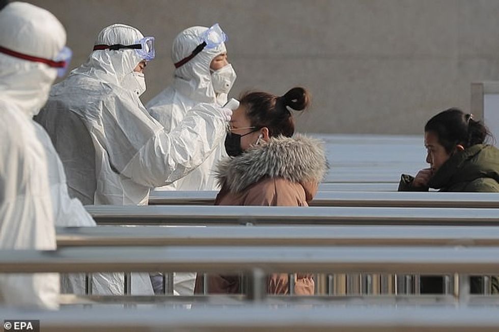 23851716 0 In Beijing today workers in white protective suits checked tempe a 22 1579949368077