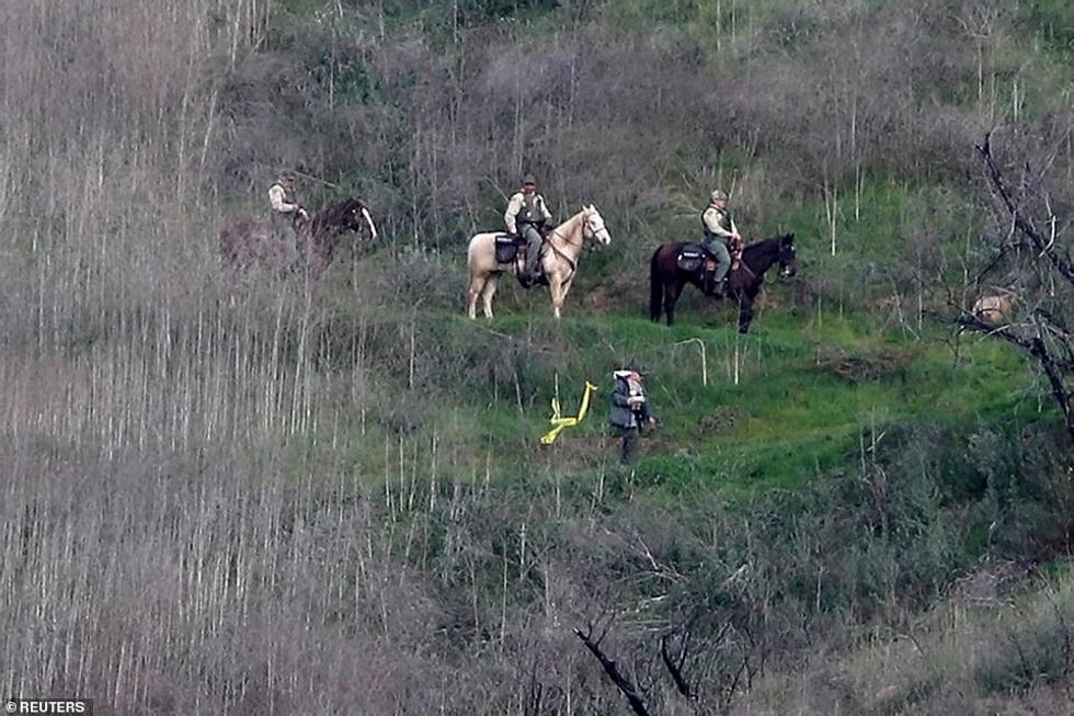 23961950 7936515 Horse mounted sherriffs patrol the area at the helicopter crash a 87 1580182159052