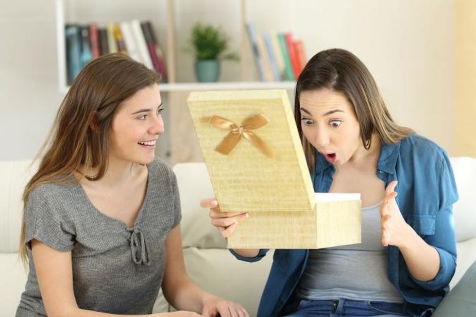 240747 girl giving gift to friend