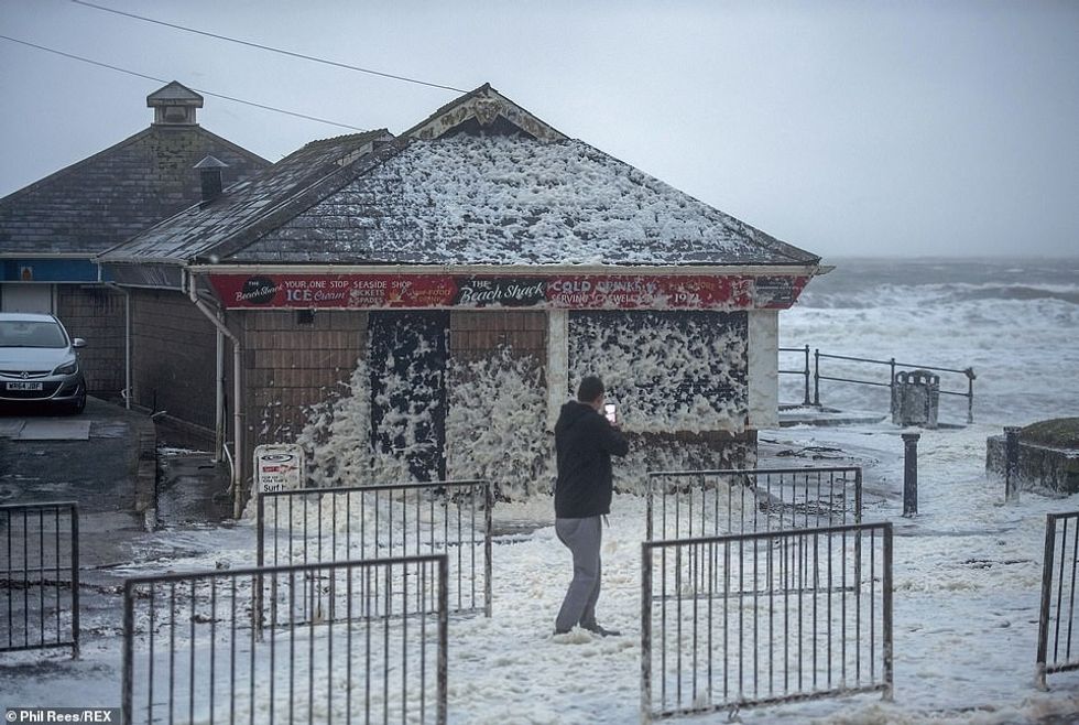 24502432 7983523 High winds from Storm Ciara whip up foam onto the road at Caswel m 5 1581243341358