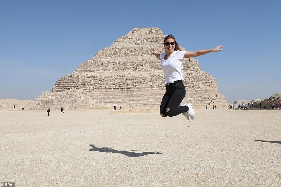 25618124 8079495 A tourist poses for photos in front of the King Djoser s step py a 21 1583492089054