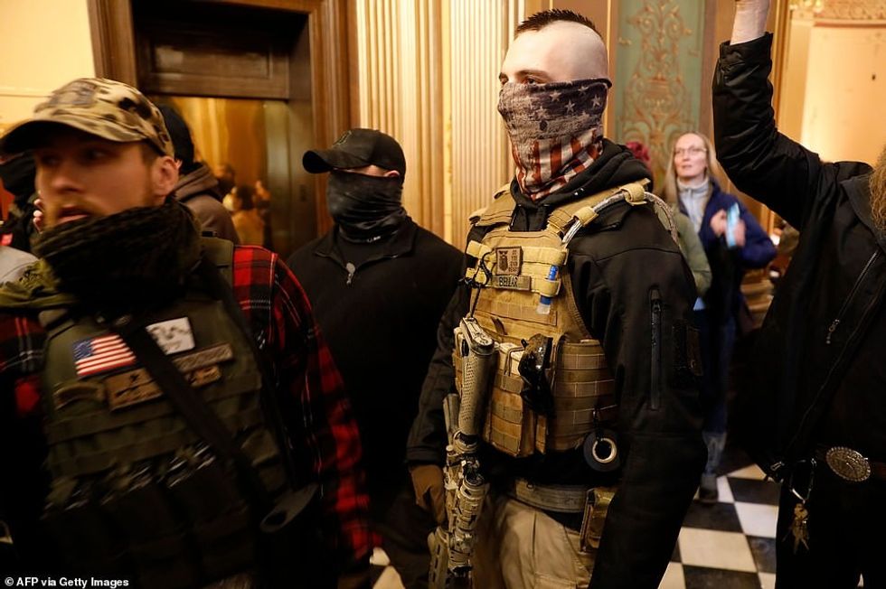 27856086 8275171 Armed men are seen inside the Michigan State Capitol after they a 110 1588283688547
