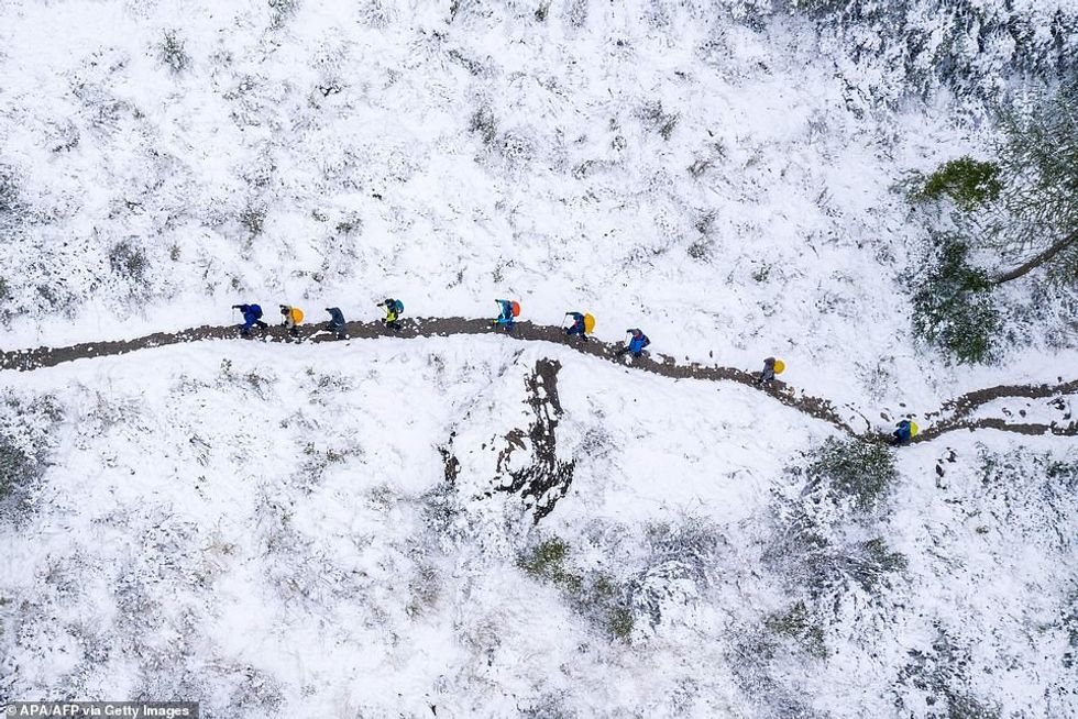 33652972 8775733 An aerial picture shows hikers walking at the snow covered Gross a 58 1601130874980