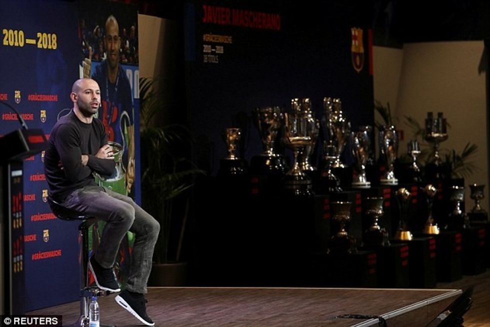 48886E9600000578 5306625 The Argentine defender sits on the podium with his 18 trophies o a 1 1516803467330