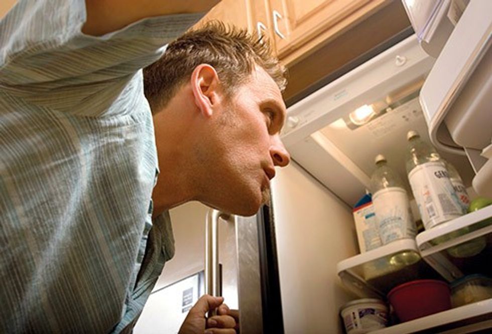 493ss thinkstock rf young man looking into refrigerator