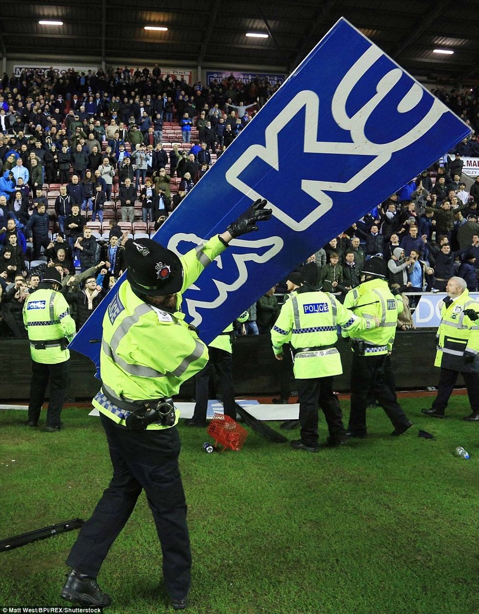 49638E7C00000578 5410495 A piece of the advertising hoardings is thrown in the direction a 14 1519123831018