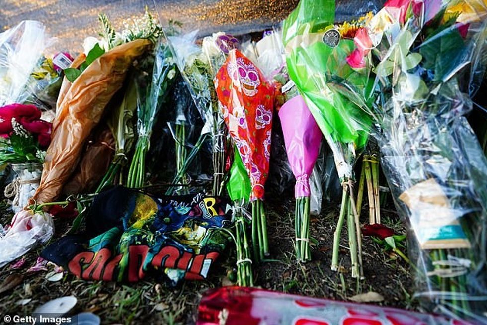 51131991 10831881 Mourners left pictures flowers candles and other mementoes to ho a 2 1653349389489