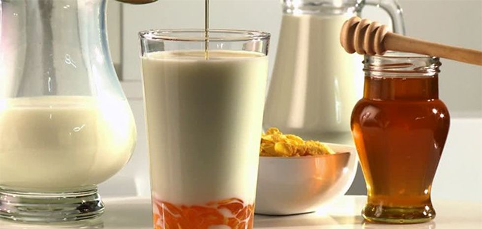 550470592-honey-jar-honey-dipper-cold-illness-adding