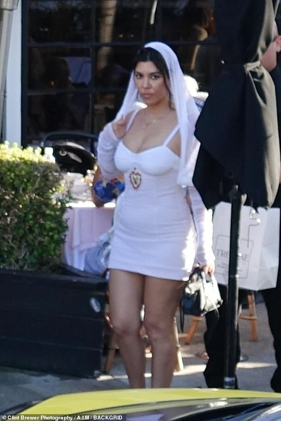 57855763 10821431 And the bride wore a white mini dress Kourtney slipped into a ve a 2 1652710711036