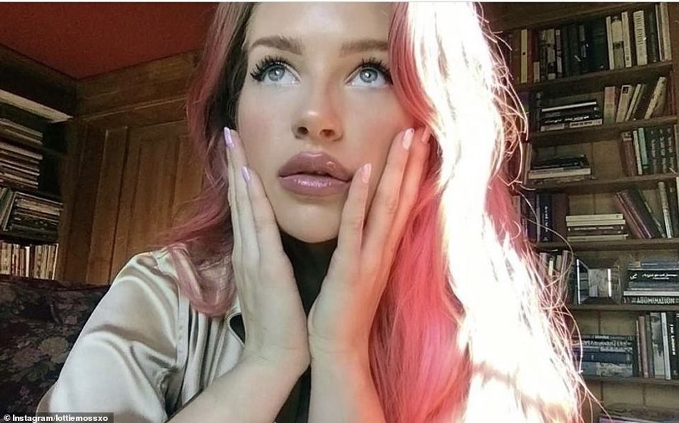 58286523 10854537 Wooden bookshelves line the living room of the country mansion i a 8 1653552697669