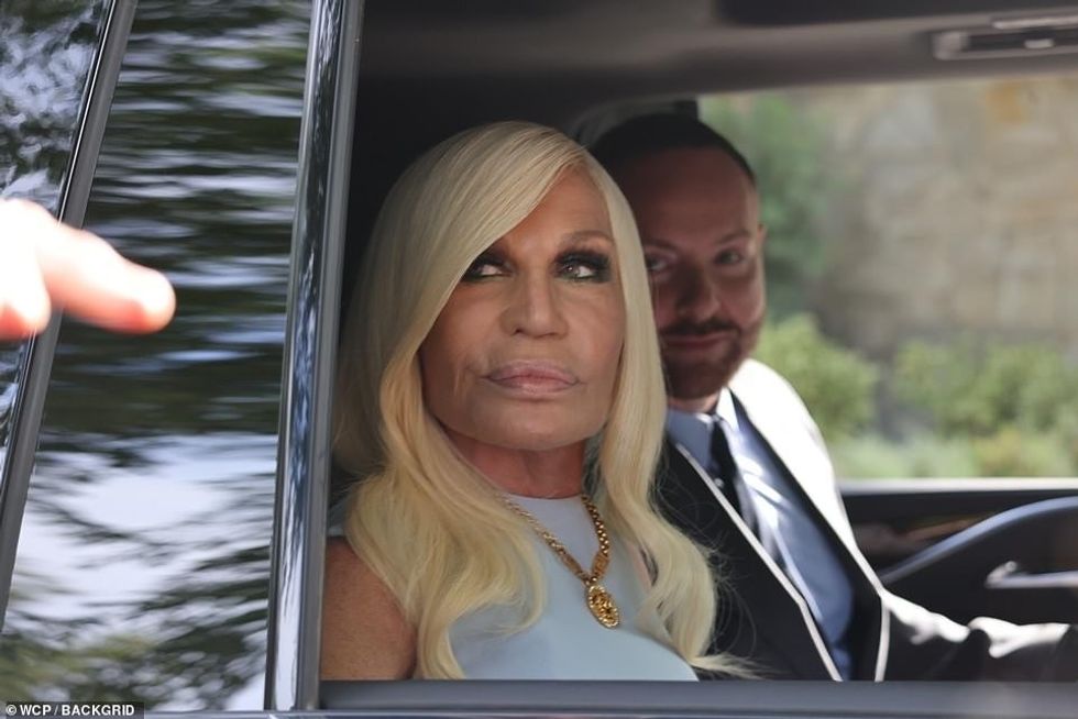 58898085 10902719 Plus one The 67 year old fashionista was accompanied by a male c a 25 1654832270770