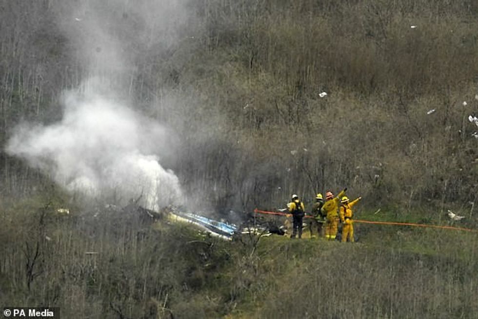 61280909 11115285 Firefighters work at the scene of the helicopter crash where for a 18 1660631899502