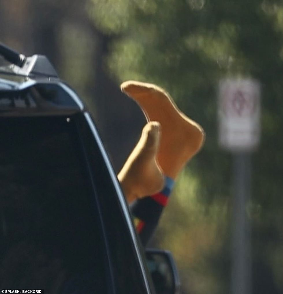 62135545 11186907 A close up showing the model s feet outside of the car window as m 13 1662554144647