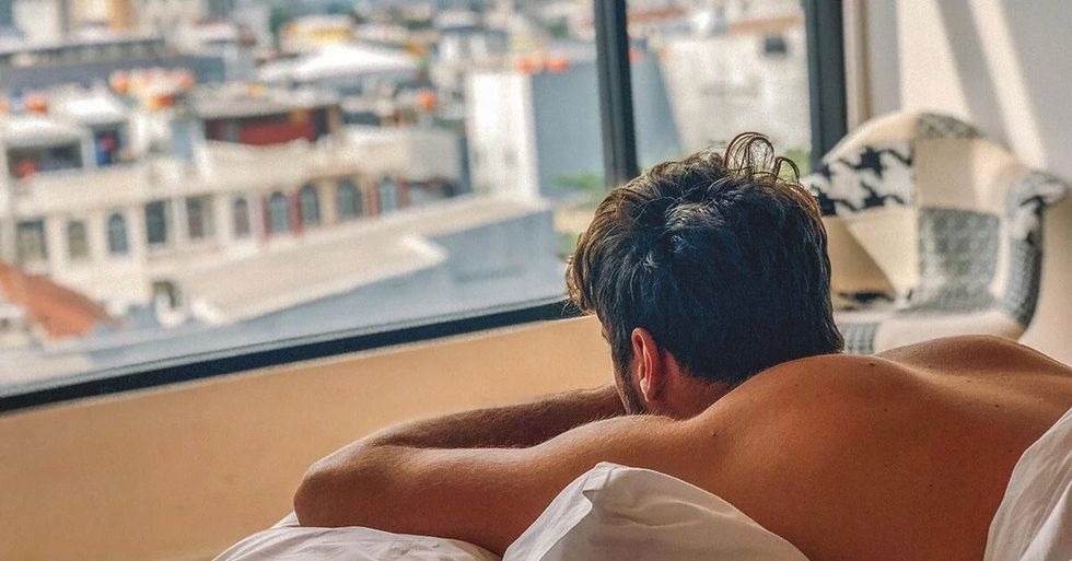 6215 man bed looking window