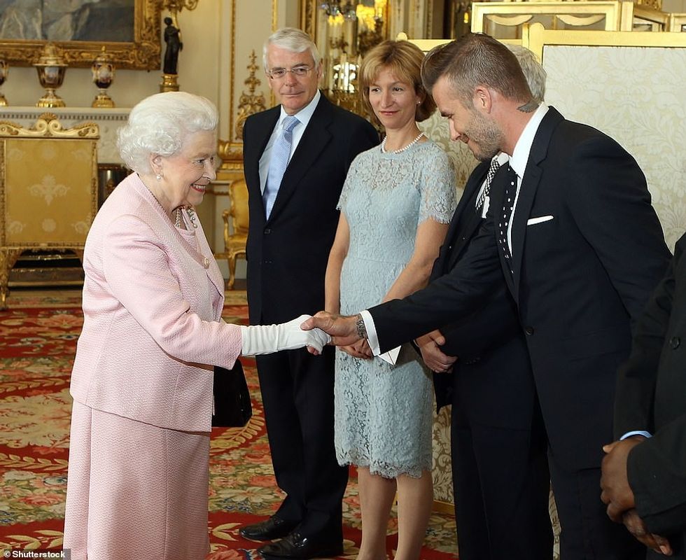 62487039 11219511 Her Majesty and Beckham shake hands at The Queen s Young Leaders a 24 1663344536275