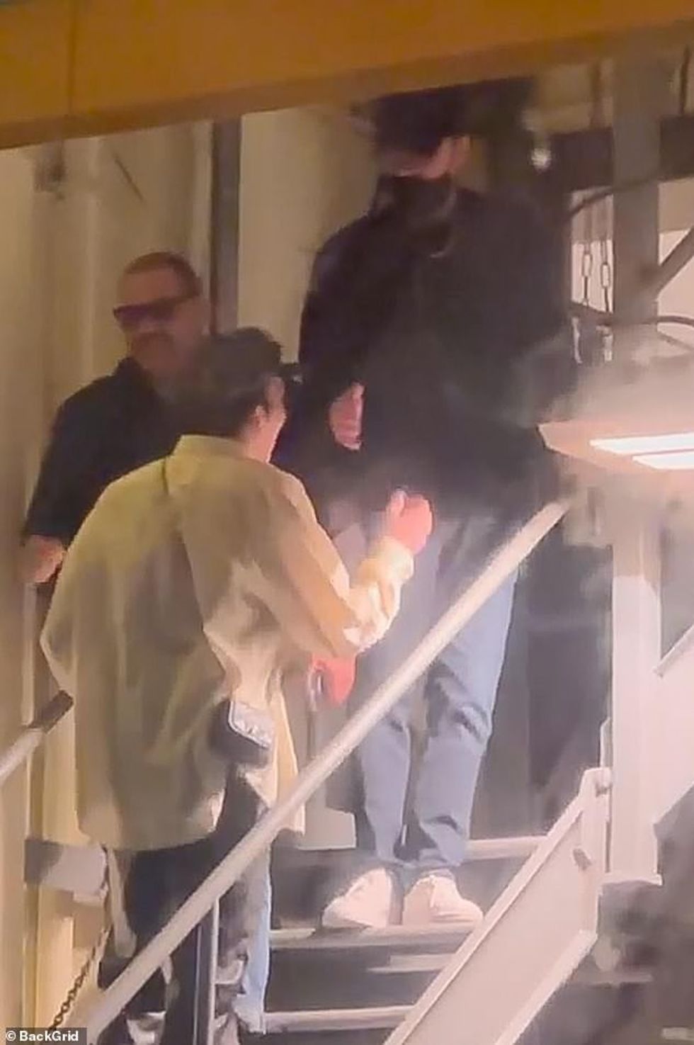 70635751 12052801 Mingling Leo conversed with a male friend shaking his hand befor a 2 1683333125402