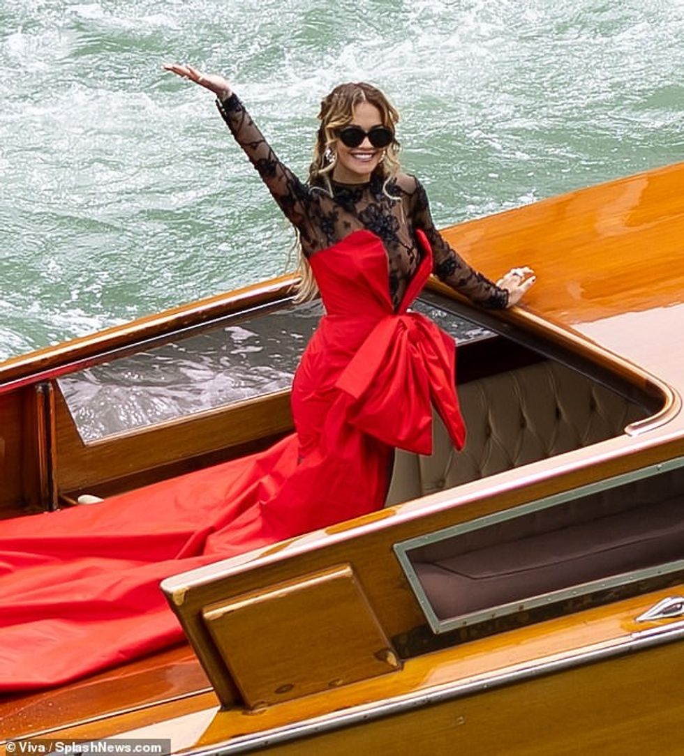 74910163 12464927 Rita Ora makes a grand entrance in dramatic red satin gown with m 12 1693472315621