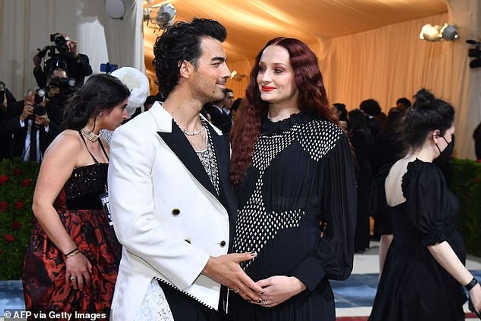 75812789 12564425 Joe Jonas and pregnant Sophie Turner were seen posing on the red a 74 1695773806041