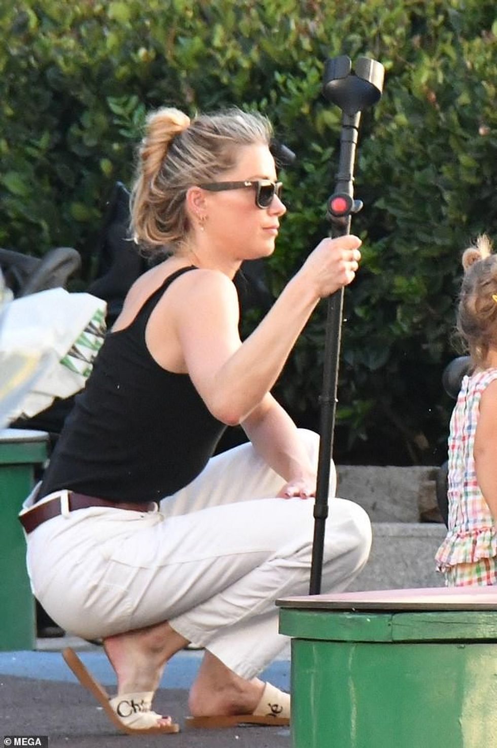 76126351 12590505 Healing She squatted down to watch the kids play all while using a 116 1696368687249