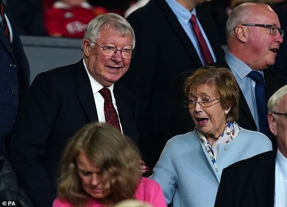76251213 12636031 The Fergusons watching a football game together from the stands a 48 1697465548006