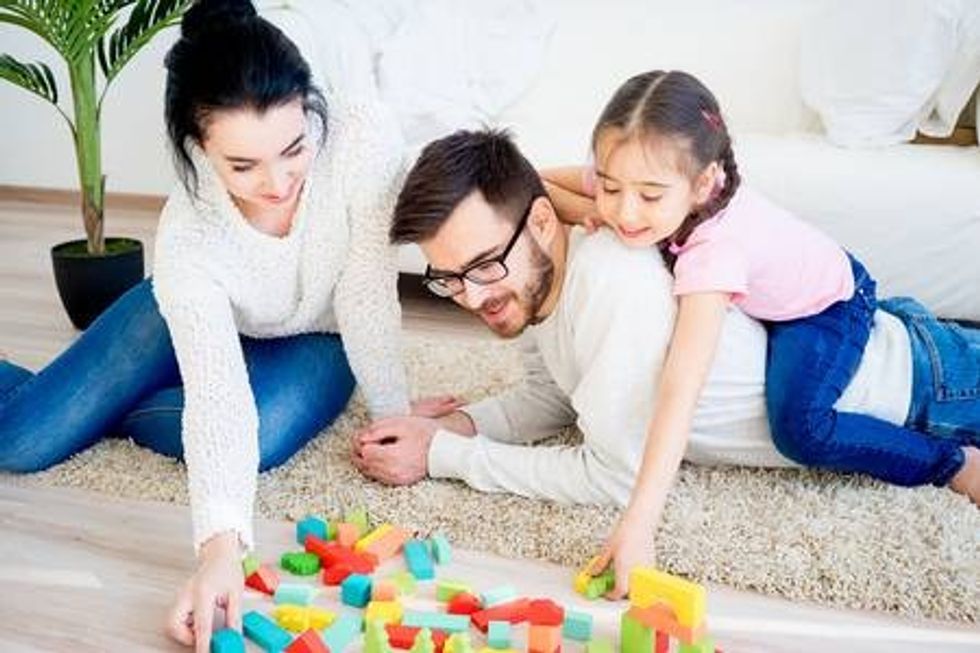 76446875 family playing with toy blocks