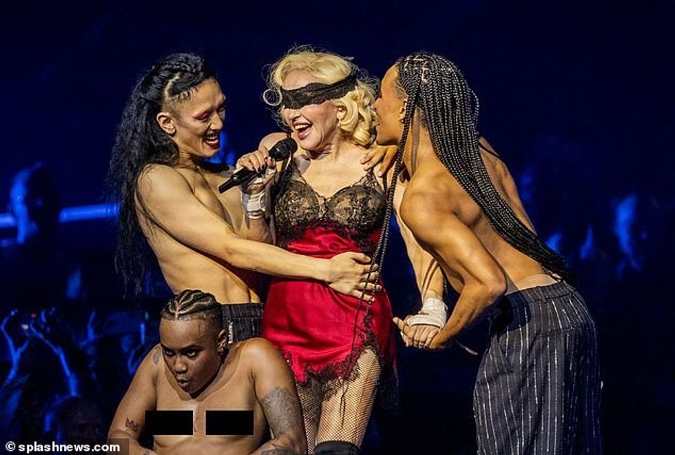 76603745 12634747 Racy During the show Madonna sent temperatures soaring as she hi a 59 1697496626404