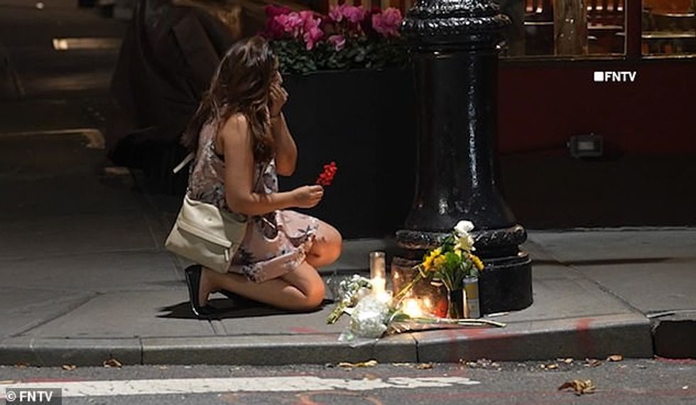 77144365 12685463 A fan breaks down in tears as she lays a flower at the impromptu a 99 1698594553552